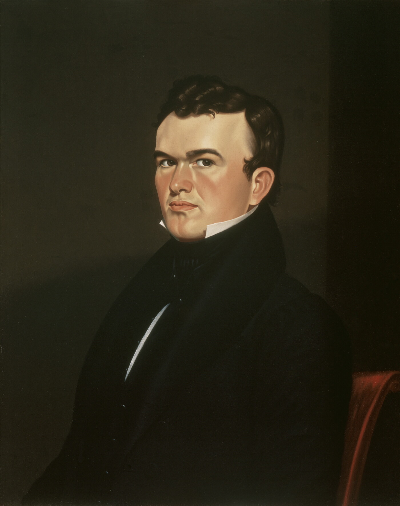 An oil painting of a serious-looking, seated White man with dark hair wearing a black jacket with a high collar.