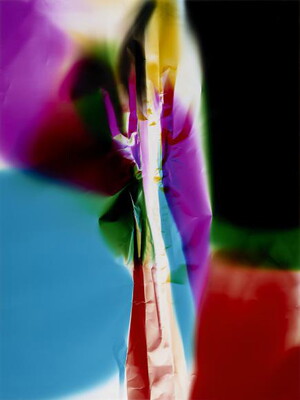 An abstract color photograph of what looks like crumpled paper in the center surrounded by pink, blue, yellow, green, black, and red.