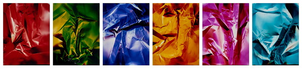 A series of six abstract color photograph of what looks like crumpled paper in (L-R) red, green, blue, yellow, pink, and light blue.