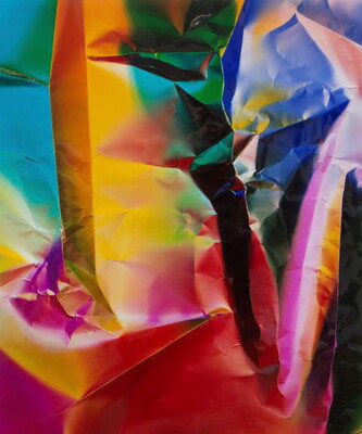 An abstract color photograph of what looks like crumpled paper in blue, pink, yellow, green, and red.