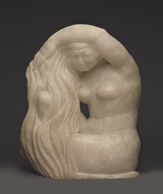 A white stone sculpture of a seated nude woman washing her long hair.