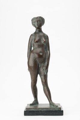 A bronze sculpture of a nude woman standing with her weight on her right leg and her left leg somewhat extended.