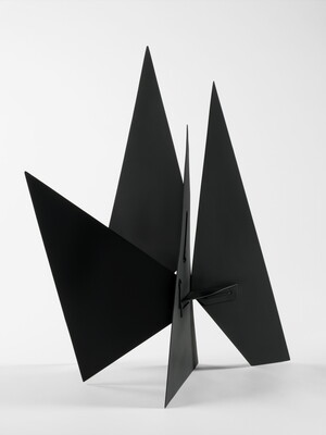 A black abstract tabletop sculpture with lots of triangular points.