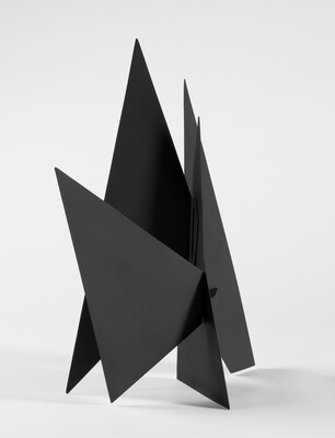 A black abstract tabletop sculpture with lots of triangular points.