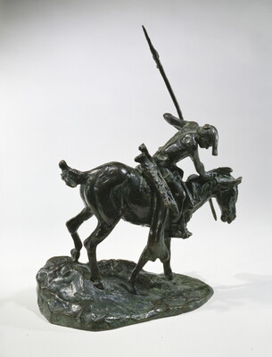 A bronze sculpture of an Indigenous man on horseback holding a spear pointed toward the ground as he studies footprints there.
