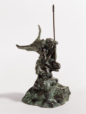A bronze sculpture of a crouching Indigenous person holding a spear with a open-winged bird perched on their shoulder.