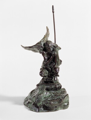 A bronze sculpture of a crouching Indigenous person holding a spear with a open-winged bird perched on their shoulder.