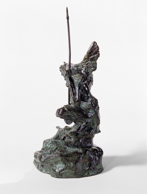 A bronze sculpture of a crouching Indigenous person holding a spear with a open-winged bird perched on their shoulder.