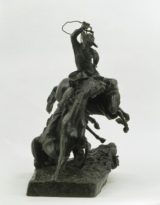 A bronze sculpture of a cowboy riding a horse while roping another horse that has cowboy on its back.