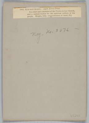 A sepia-toned portrait photograph of a young, Indigenous man seated, wearing traditional dress.