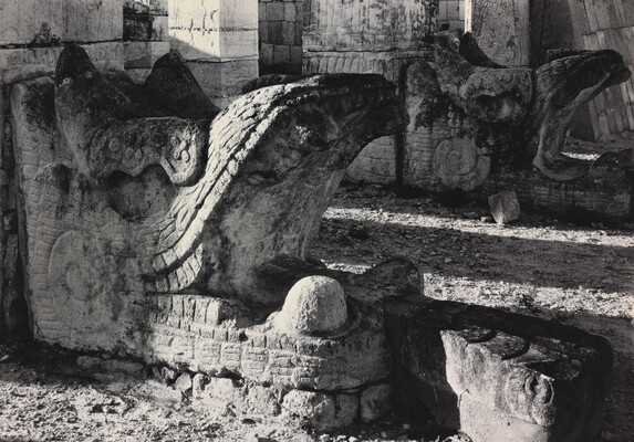 A black-and-white photograph of an ancient stone architectural embellishment in the form of an open-mouthed beast.