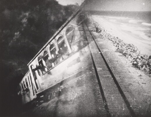 A black-and-white photograph of a train car overlayed with a photograph of train tracks.