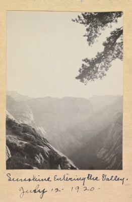 A black-and-white photograph of a mountainous landscape on a sunny day, labeled "Sunshine Entering the Valley, July 12, 1920."