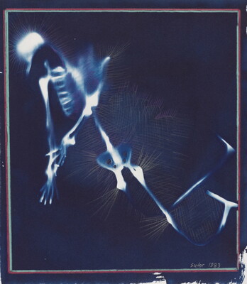 A color photograph of a glowing, blurry, white and blue skeleton-like shape on a dark blue background.