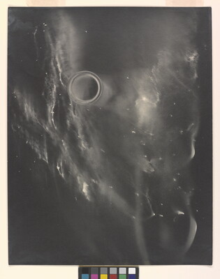 An abstract black-and-white photograph of what resembles a foggy galaxy against a black background.