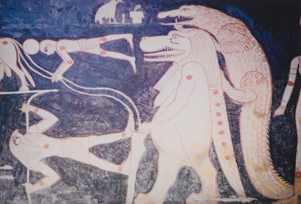 A color photograph of a mural with white and red hieroglyphs featuring several Egyptian gods, people, and what looks like a lion walking upright with a crocodile climbing on its back.