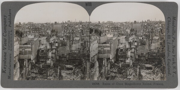 Two almost identical side-by-side black-and-white photographs of a city in ruins covered in debris.