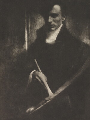A dark, soft-focus black-and-white photograph of a White man looking down at a paintbrush and palette in his hands.