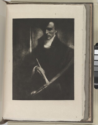 A dark, soft-focus black-and-white photograph of a White man looking down at a paintbrush and palette in his hands.