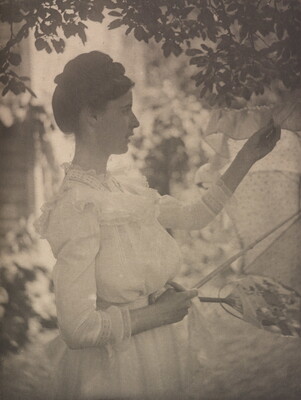 A soft-focus, black-and-white photograph of a White woman in profile wearing a white long-sleeved dress holding a white parasol under a tree.