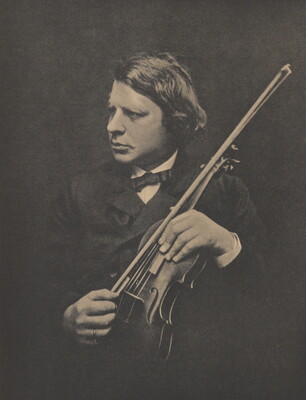 A black-and-white photograph of a White man looking off to the side, wearing a suit, holding a violin and bow.