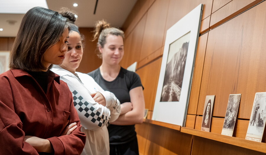 College students look at artwork in the Carter library.