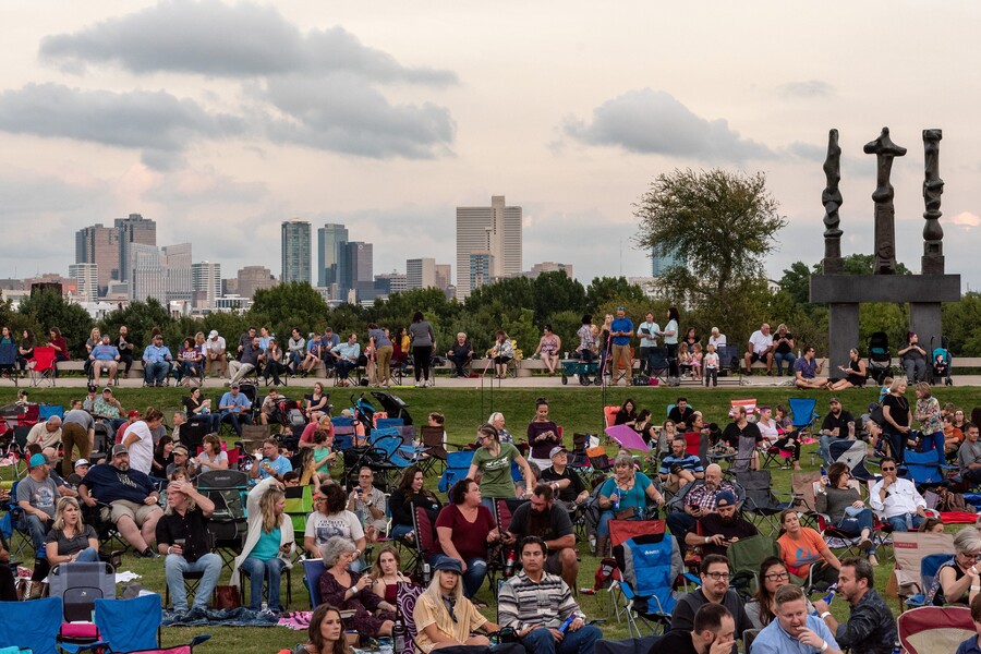 Crowd sits on Carter lawn with FW skyline and Henry Moore sculpture