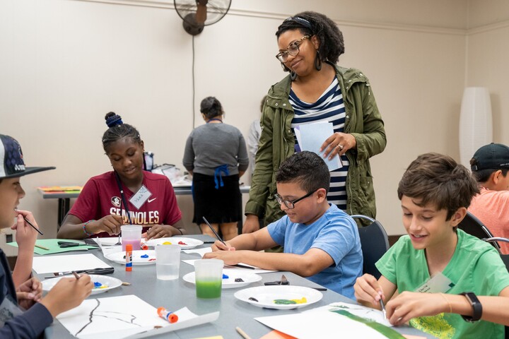 Carter Community Artist with children at table