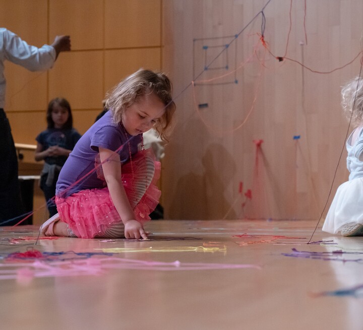 two girls making art on a stage