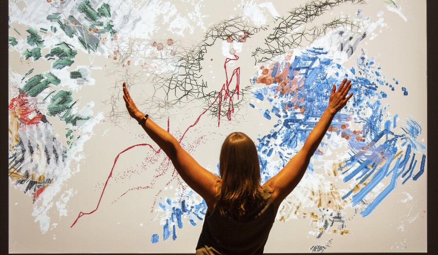 Woman interacting with Camille Utterback Untitled 5