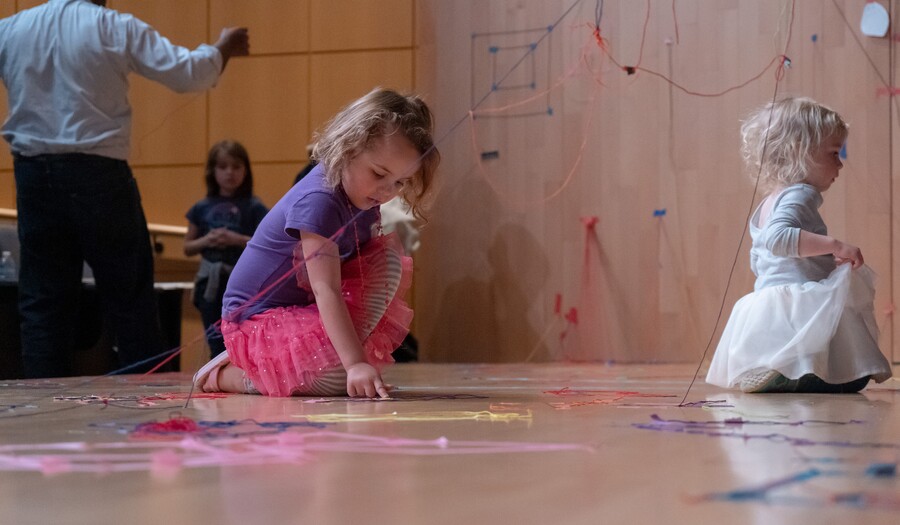 two girls making art on a stage