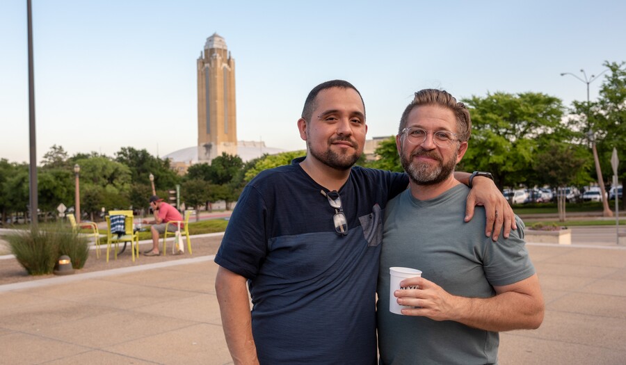 Two men stand on the Carter porch with a drink