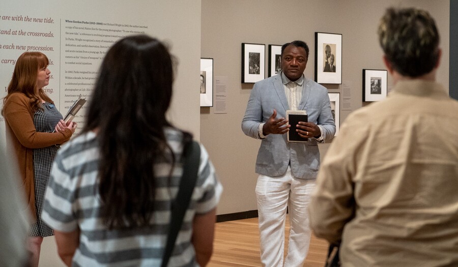 Man giving a tour in Gordon Parks exhibition