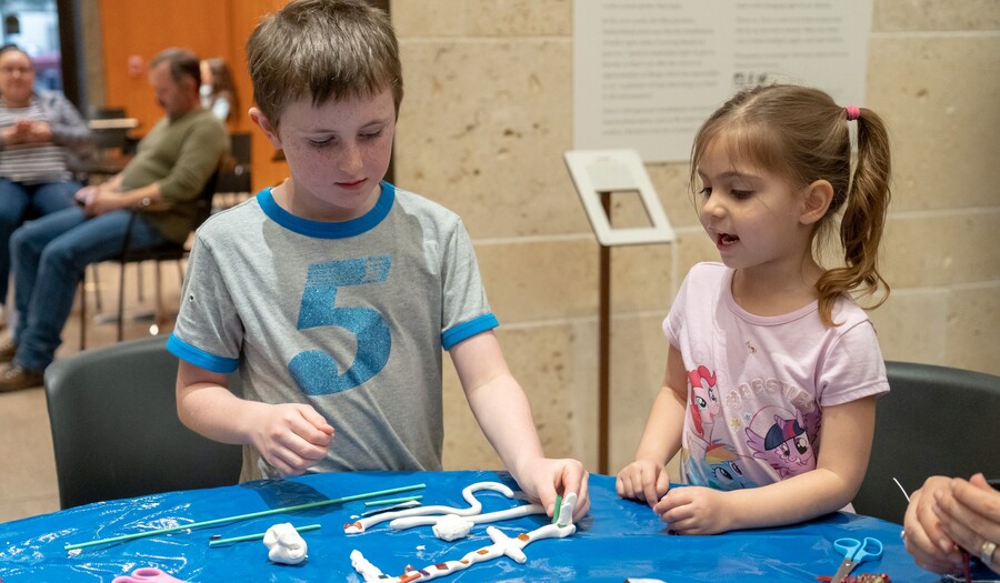 boy and girl making a sculpture out of clay