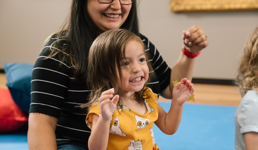 mom and toddle laughing in a gallery