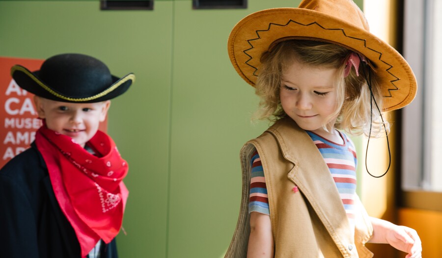 little boy and little girl playing dress up