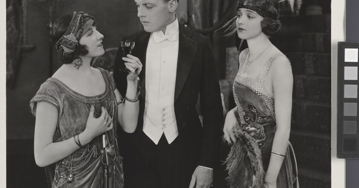 [Woman with wine glass speaking to Forrest Stanley and ...